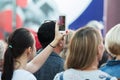 Unidentified woman filming scene by mobile phone during a concert dedicated Moscow city day on September 9, 2019