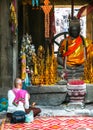 Unidentified woman pray near buddhist altar