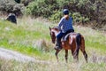 Unidentified woman riding a horse on the hills of south San Francisco bay area, Santa Clara county, San Jose, California