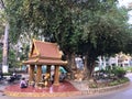 An unidentified woman sits praying before Ya Tep spirit shrine located near Royal Residence