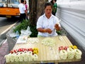 Unidentified woman to make flower garlands in Thai style for sell to worship at Wat Sutat