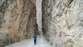 Unidentified woman walking along Dark Canyon in Town of Kemaliye or Egin in Erzincan, Turkey