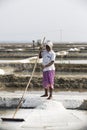 Unidentified woman workers picking up, collecting the salt, in big salt fields, manual labour, organic agriculture, very hard job