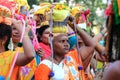 Women devotees carry scared pots in their heads and participates in the Thaipusam festival