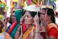 Women devotees carry scared pots in their heads and participates in the Thaipusam festival