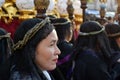 Unidentified Women penitents in garb and crown of bitter herbs carrying angel figurine scepter standing on the churchyard on Lente Royalty Free Stock Photo