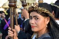 Unidentified Women penitents in garb and crown of bitter herbs carrying angel figurine scepter standing on the churchyard on Lente Royalty Free Stock Photo