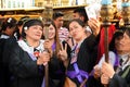 Unidentified Women penitents in garb and crown of bitter herbs carrying angel figurine scepter taking selfie on the churchyard on