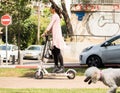 Unidentified Women riding an electric scooter