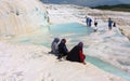 Unidentified women watch Pamukkale known with its travertine terraces and health-giving pools with mineral water. Turkey. Royalty Free Stock Photo