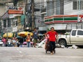 An unidentified worker pushes a cart full of vegetables through the vegetable market