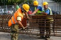 Unidentified workers working with concrete iron at a construction site