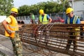 Unidentified workers working with concrete iron at a construction site