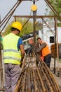 Unidentified workers working with concrete iron at a construction site