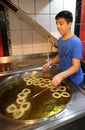 Unidentified Young Boy frying Turkish Churro Halka Tatli at Dessert Shop