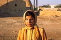 Unidentified young girl with her traditional dressing and colorful scarf, Syria