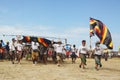 Unidentified young men carrying a huge kite