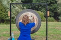 Woman gives a demonstration with a big gong
