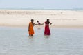 Unidentified young women girl couple taking a walk at beautiful sunny morning at Danushkodi beach