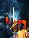 Unidentify buddhism temple visitors praying with large size smoking joss sticks