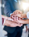 Unified behind their goal. a group of unrecognizable businesspeople piling their hands on top of each other in the Royalty Free Stock Photo