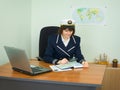 In uniform of captain examines geographical