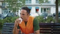 Uniform guy eating food enjoying break at wooden bench closeup. Man resting Royalty Free Stock Photo