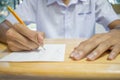 Uniform School Asian students taking exams writing answer optical form with pencil in high school classroom, view of having exams Royalty Free Stock Photo