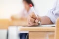 Uniform School Asian students taking exams writing answer optical form with pencil in high school classroom, view of having exams Royalty Free Stock Photo