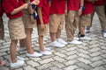 Uniformed children aligned legs standing on school playground