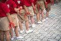 Uniformed children aligned legs