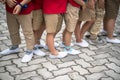 Uniformed children aligned legs