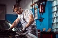 Uniformed mechanic in service station