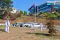 Uniformed naval personnel lowering the New Zealand flag