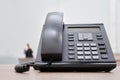 Unify landline phone stands on a wooden table in the office - Moscow, Russia, April 17, 2022