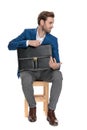 Unimpressed businessman holding his briefcase and disagreeing Royalty Free Stock Photo