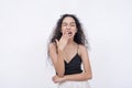 An unimpressed young woman yawns in a mocking fashion. Bored and condescending. on a white background