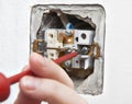 Uninstall the old light switch, closeup. Royalty Free Stock Photo