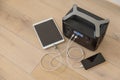 Uninterruptible power supply source. Portable power station charching tablet and smartphone Royalty Free Stock Photo
