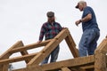 Skilled men building a barn at a Festival