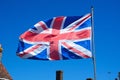 Union jack flag against a blue sky. Royalty Free Stock Photo
