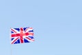 Union Jack flag of Great Britain UK Blowing in the wind against a empty blue sky Royalty Free Stock Photo