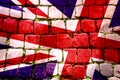 A Union Jack flag overlaid onto Cobbles, with weed and grass growing between the cobblestones