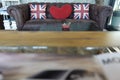 Union jack flag and red heart pillow on brown sofa,pillow decoration object, England flag on object use for interior Royalty Free Stock Photo