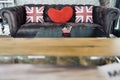 Union jack flag and red heart pillow on brown sofa,pillow decoration object, England flag on object use for interior Royalty Free Stock Photo