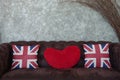 Union jack flag and red heart pillow on brown sofa,pillow decoration object, England flag on object use for interior Royalty Free Stock Photo