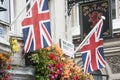 2 Union Jack flags and a pub sign in London