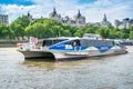 Union Jack flies on London river bus passing Somerset House.