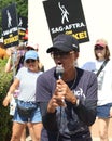 Union members walk the picket line in support of the SAG-AFTRA and WGA