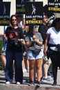 Union members walk the picket line in support of the SAG-AFTRA and WGA